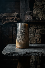 Front view of Yggdrasil Voyage buffalo horn coffee mug with Viking longship beneath world tree design