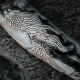 Close-up of the Fenrir wolf design engraved by hand on genuine buffalo horn